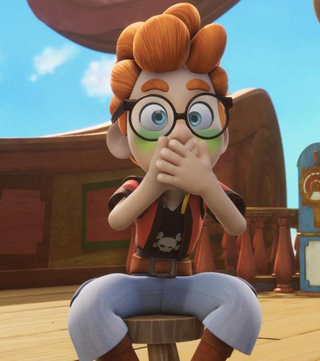 An Deck des Schiffes sitzt auf einem Hocker Alexander und hält sich mit beiden Händen den Mund zu. Sein Gesicht ist grün und die Augen weit aufgerissen. Neben ihm steht Bart Fischkopp mit einer Landkarte.