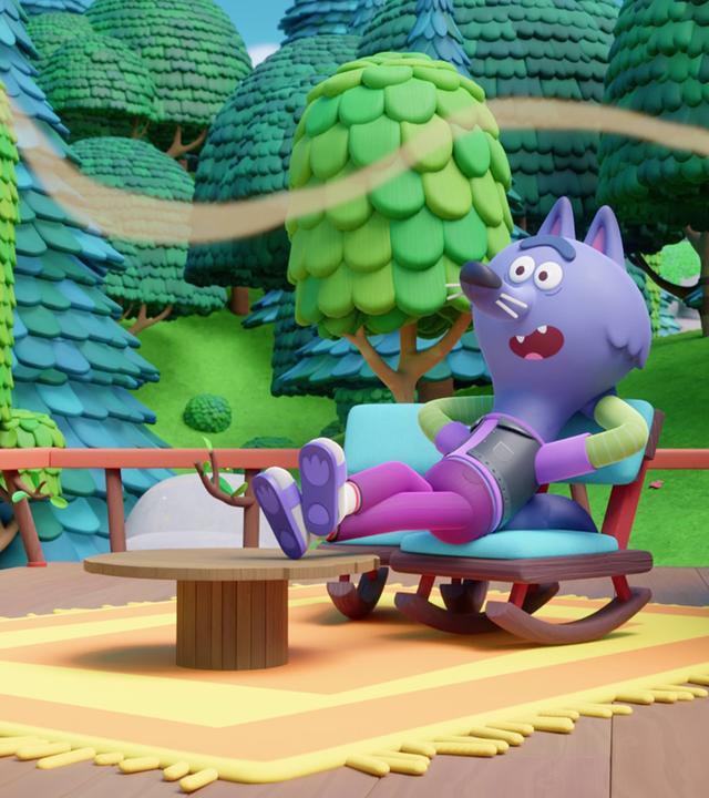 In einem Schaukelstuhl liegend, die Füße auf dem davorstehenden, runden Beistelltischchen, sitzt der lilafarbene Wolf Wilf. Er hat die Arme hinter dem Kopf verschränkt und scheint gerade jetzt den Kuchenduft zu bemerken, der wellenförmig durchs Bild weht. Er sitzt auf seiner Terrasse mit einem gelben Teppich, im Hintergrund sehen wir einen Wald mit grünen und bläulichen Bäumen.