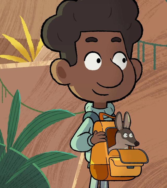 Ein rothaariges Mädchen steht mit den Händen in die Hüfte gestützt neben einem Schwarzen Jungen. Er trägt eine Tasche am Bauch, aus dem ein kleines Känguru herausschaut.