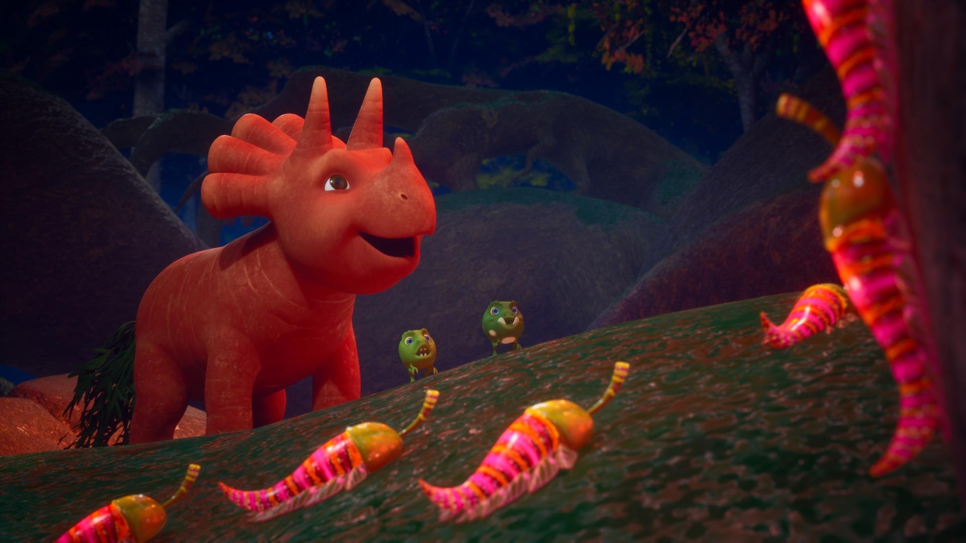 Ginger und ihre Erbs-Rex-Freunde laufen durch einen nächtlichen Wald. Sie stehen staunend vor leuchtenden Wesen, die aussehen wie Chilis mit kleinen Beinchen. Ginger ist ein Saurier-Mädchen, das einer Karotte ähnelt, Erbs-Rexe sehen Erbsen ähnlich.