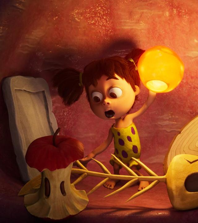 Das Menschenmädchen Lucy, ist im Bauch eines Tyrannosaurus-Rex. Im Bauch von Rexie sehen wir einen abgeknabberten Apfel, eine Frischgräte, eine Holzscheibe und eine Steinplatte. Lucy hält eine Art beleuchtete Bernsteinvase in der Hand.