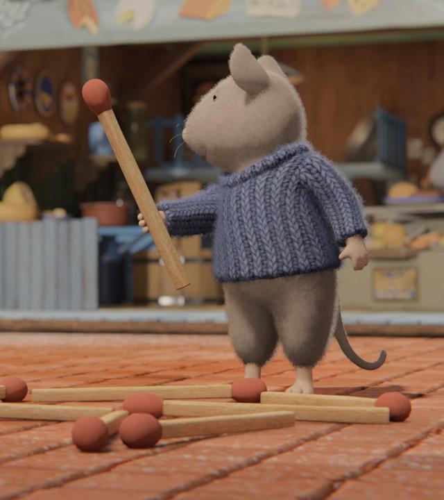 Sam und Julia stehen im Hof des Mäusehauses vor dem Käseladen. Sam hat ein großes Streichholz in der rechten Hand und schaut fragend zu Julia. Julia scheint ihm die Anweisung zu geben, wohin er das Streichholz zu den bereits auf dem Boden liegenden Streichhölzern legen soll.  Dort scheint aus den Hölzern ein Grundriss eines Gebäudes zu entstehen.