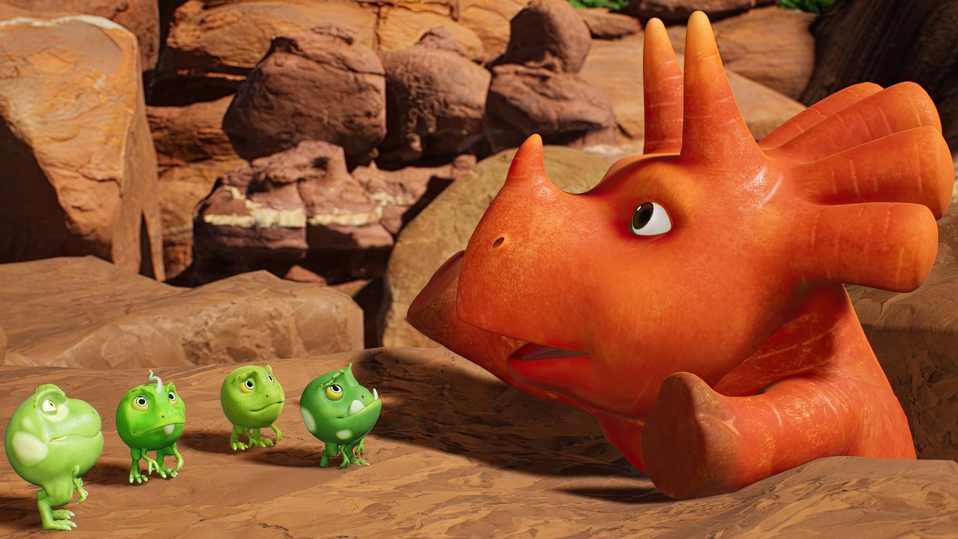 Ginger, das Sauriermädchen, das aussieht wie eine Karotte, steckt in einer Felsspalte fest. Vor ihr stehen vier kleine, grüne, runde Wesen - die sogenannten Erbs-Rexe. Sie schauen ein wenig hilflos.