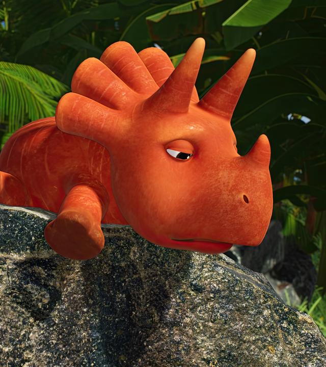 Auf einem Felsen liegt bäuchlings ein orangefarbener Dinosaurier, der aussieht wie eine Karotte, und streckt alle vier Beine von sich. Es ist das Trikarottops-Mädchen Ginger. Sie schaut traurig. Neben ihr stehen die Erbs-Rexe Minzi, Wasabi und Split.
