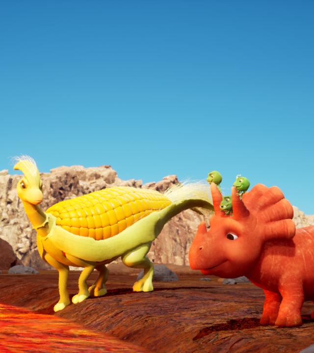 Ein gelber Dinosaurier, dessen Körper ein Maiskolben ist, schaut lächelnd zu Ginger, die neben ihm steht. Ginger ist ein Dinosaurier-Mädchen, das einer Karotte ähnelt. Im Hintergrund fließt ein kleiner, rotglühender Lavastrom.