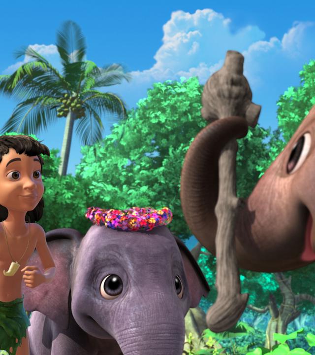 Appu hält einen Stock mit dem Rüsssel. Hita und Mogli schauen dabei zu.