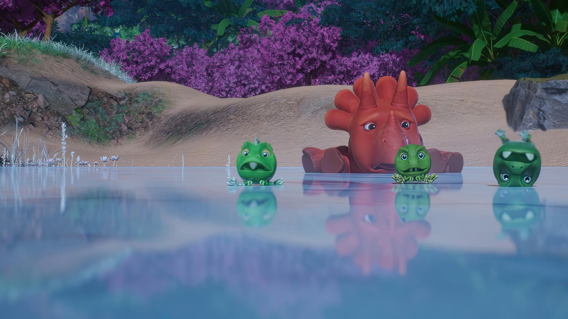 Ginger liegt flach auf einem zugefrorenen See. Vor ihr rutschen die drei Erbs-Rexe auf der Eisoberfläche herum. Einer sogar auf dem Kopf.