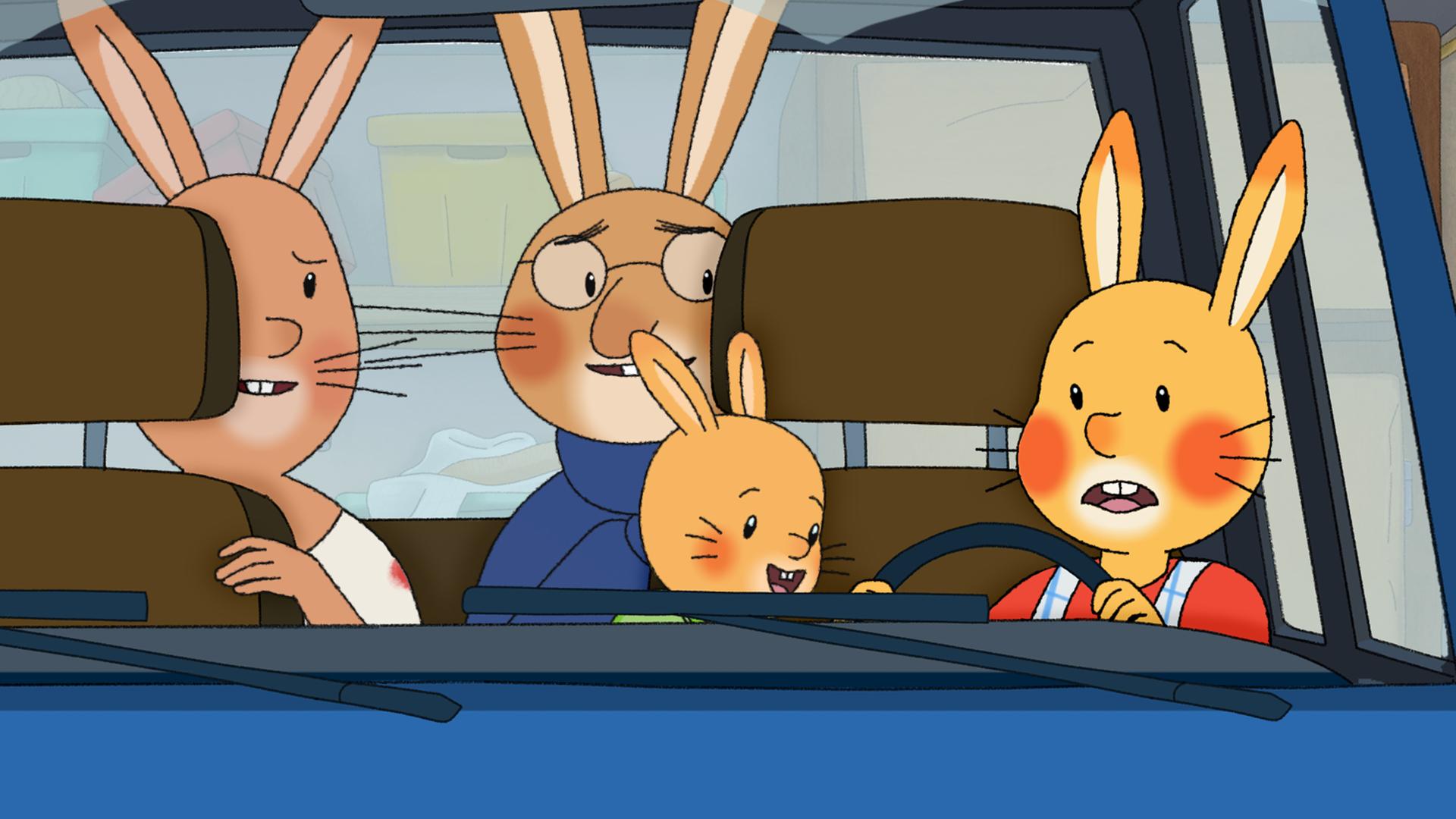 Familie Karnickel sitzt im Auto. Auf den Rücksitzen, wo sonst die Kinder sitzen, sitzen Mama und Papa und schauen nach vorne zu Karlchen. Der sitzt nämlich hinter dem Lenkrad, neben ihm sitzt seine kleine Kaninchenschwester Klara. 