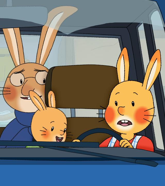 Familie Karnickel sitzt im Auto. Auf den Rücksitzen, wo sonst die Kinder sitzen, sitzen Mama und Papa und schauen nach vorne zu Karlchen. Der sitzt nämlich hinter dem Lenkrad, neben ihm sitzt seine kleine Kaninchenschwester Klara. 