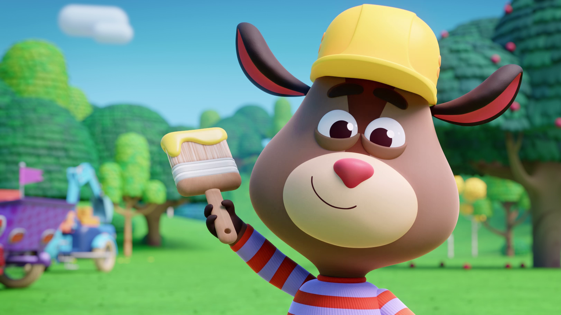 Wir sehen den Ziegenjungen Kris groß im Bild. Er trägt einen gelben Bauarbeiterhelm, in seiner rechten Hand hält er einen dicken Pinsel mit gelber Farbe. Er schaut sehr glücklich. Im Hintergrund sehen wir die Fahrzeuge der Werkel-Ferkel und Wiese und Bäume.