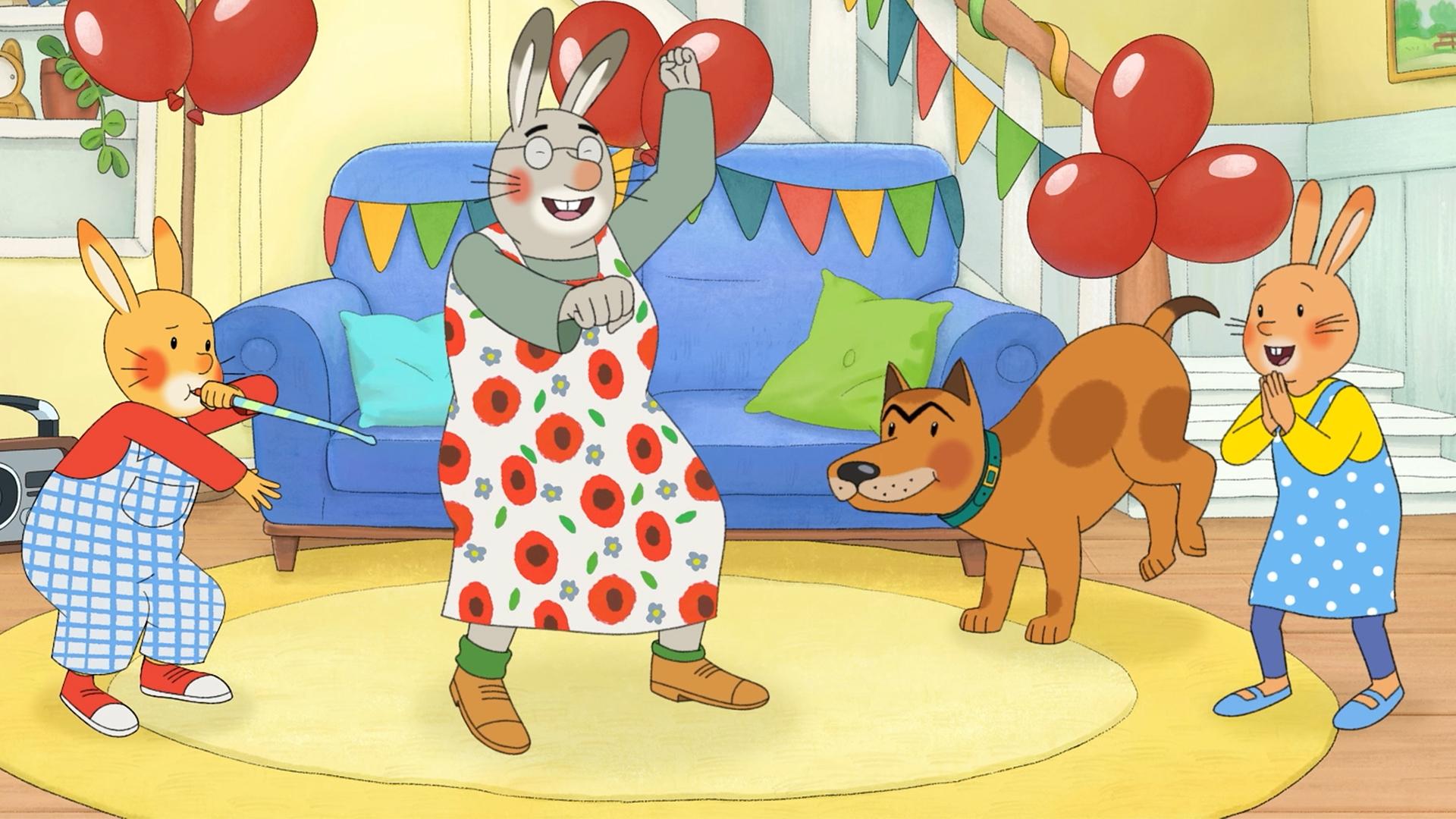 Im Wohnzimmer tanzen Monika, Oma Karlchen, Karlchen und Bello. Karlchen bläst auf einer Party-Tröte, Monika klatscht in die Hände, Bello hebt die Hinterbeine und Oma macht wilde Tanzbewegungen.