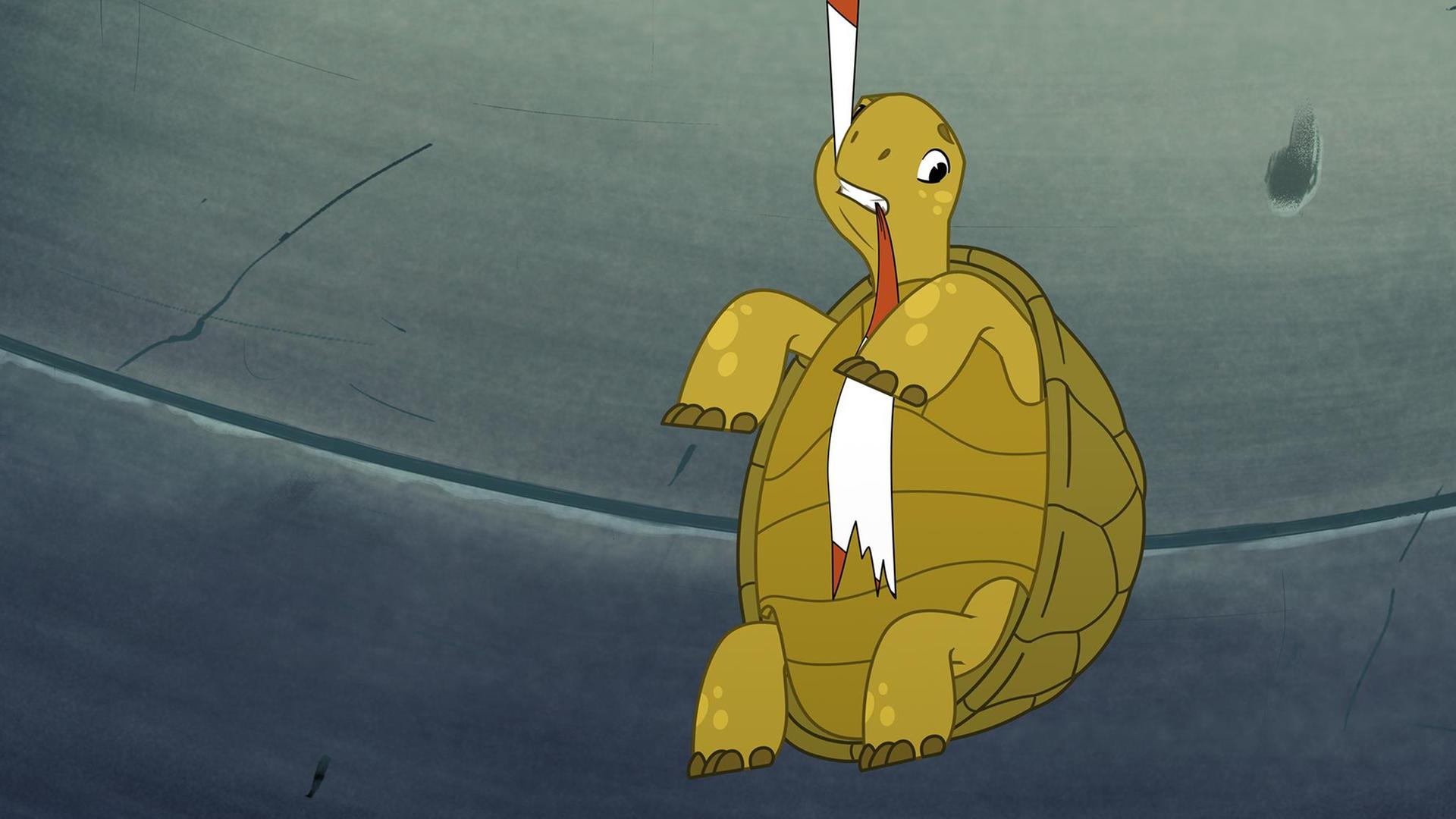 Die grüne Schildkröte Törtel beißt in ein rot-weißes Absperrband und hängt daran in der Luft. Um ihn herum ist es grau und dunkler, wie in einem Tunnel.