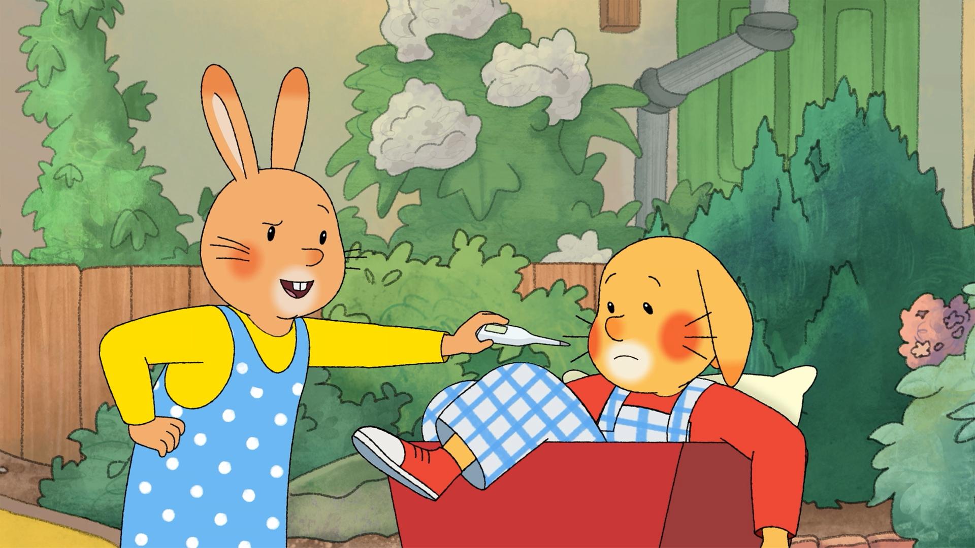 Karlchen und Monika sind im Garten. Monika hält ihm ein Fieberthermometer entgegen. Karlchen sitzt in einem roten Bollerwagen, sein Fuß hängt raus