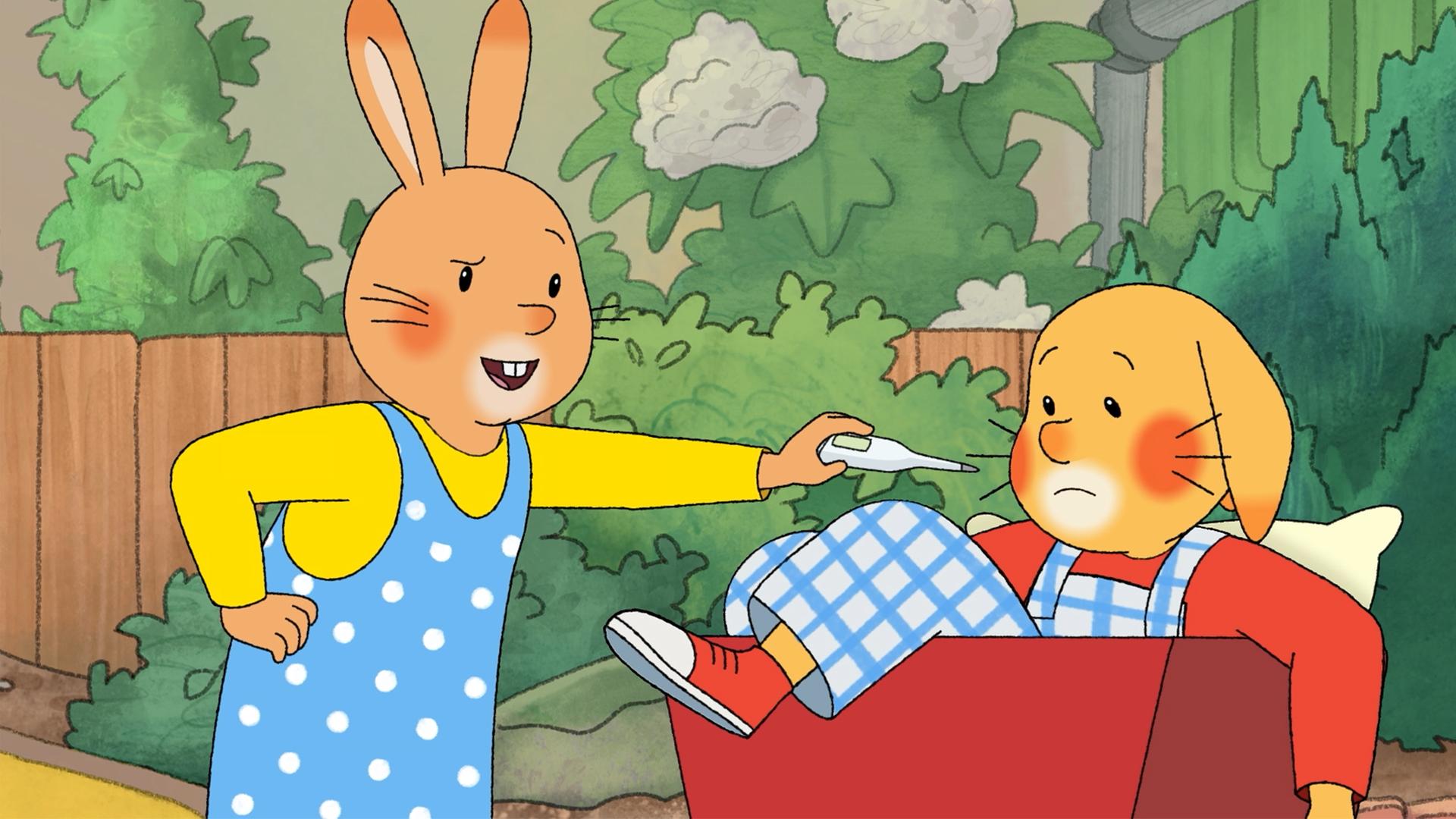 Karlchen und Monika sind im Garten. Monika hält ihm ein Fieberthermometer entgegen. Karlchen sitzt in einem roten Bollerwagen, sein Fuß hängt raus.