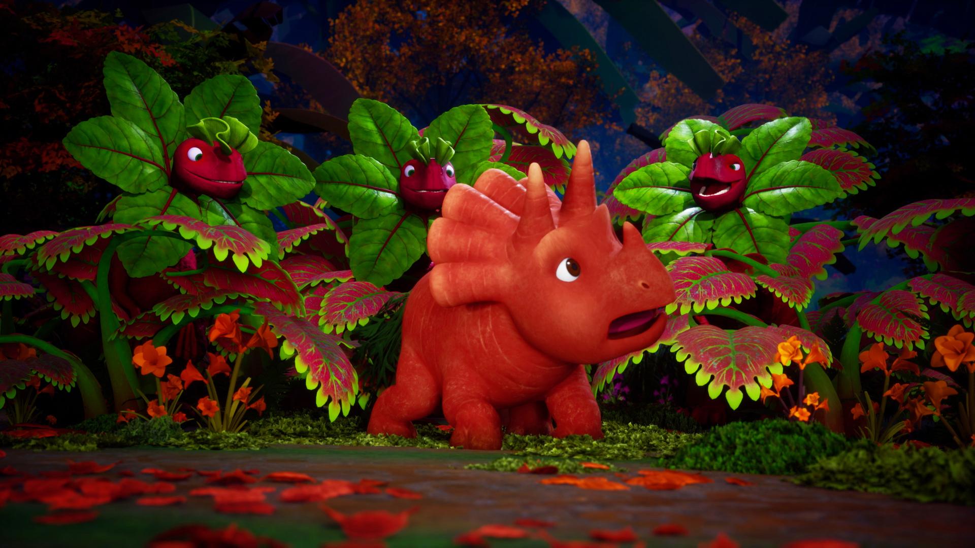 Ginger, ein Dinosaurier-Mädchen, das einer Karotte mit Gesicht ähnelt, blickt aufgeschreckt nach hinten. Dort sehen wir - gut getarnt zwischen Blättern, sogenannte Rotrüben-Saurier. Sie haben ein rotes, rübenartiges Gesicht. Um ihr Gesicht sind grüne Kohlblätter und so sieht es so aus, als hätten die Rotrüben-Saurier eine Halskrause. Es ist dunkel - im Hintergrund sehen wir Wald.