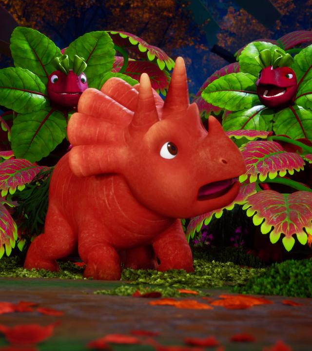 Ginger, ein Dinosaurier-Mädchen, das einer Karotte mit Gesicht ähnelt, blickt aufgeschreckt nach hinten. Dort sehen wir - gut getarnt zwischen Blättern, sogenannte Rotrüben-Saurier. Sie haben ein rotes, rübenartiges Gesicht. Um ihr Gesicht sind grüne Kohlblätter und so sieht es so aus, als hätten die Rotrüben-Saurier eine Halskrause. Es ist dunkel - im Hintergrund sehen wir Wald.