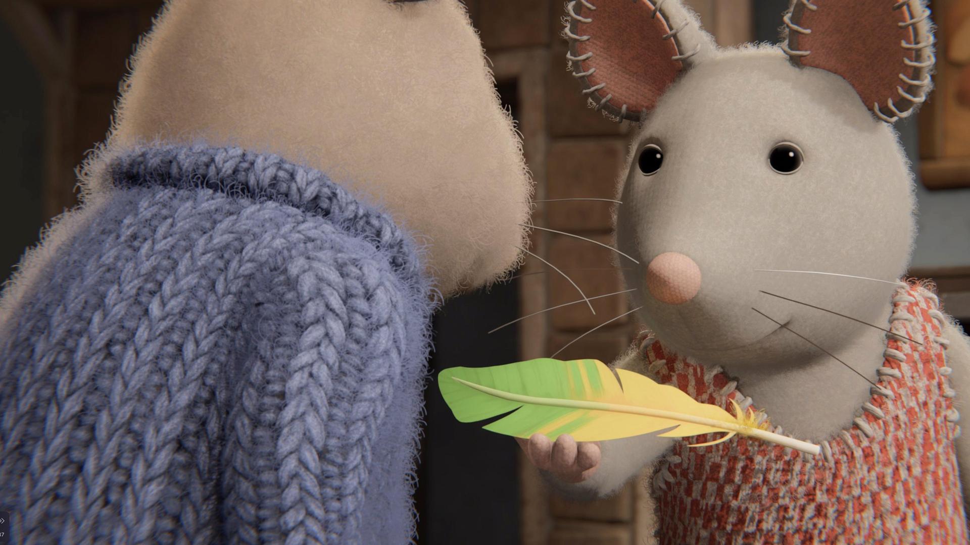 Julia steht vor Sam und hält mit ihrer rechten Hand eine Feder hoch, die zur Hälfte gelb, zur Hälfte grün ist.  Beide schauen aufmerksam auf die Feder.