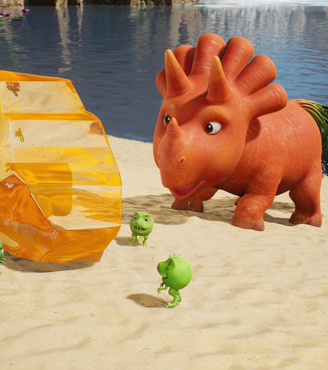 Ginger steht vor einem goldenfarbenem Stein und schaut ihn sich genau an. Auch die drei kleinen Erbs-Rexe interessieren sich für den funkelnden Bernstein.