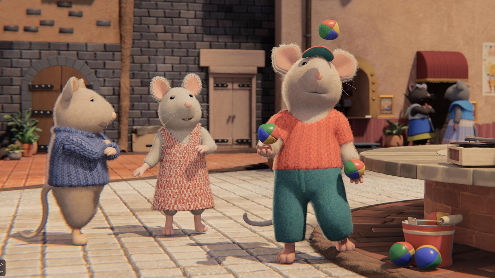 Im Hof des Mäusehauses steht Dan neben dem Brunnen und jongliert mit drei bunten Jonglierbällen Julia steht schräg hinter ihm und schaut ihm bewundernd zu. Sam steht neben Julia und hat die Arme beleidigt vor der Brust verschränkt. Hinter ihnen sieht man die Fassade des Mäusehauses.