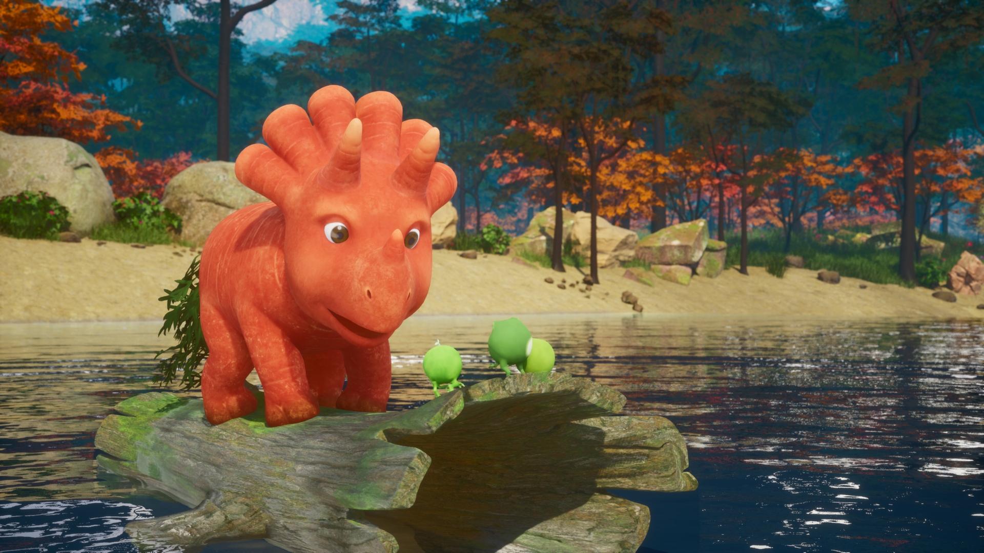 Das Trikarottops-Mädchen Ginger, eine Karotte, die aussieht wie ein Dinosaurier, steht auf einem hohlen Baumstamm und treibt auf einem See. Ganz vorne auf dem Baumstamm stehen die drei Erbs-Rexe. Erbs-Rexe sind Erbsen, die aussehen wie Dinosaurier mit kleinen Ärmchen und Beinchen. Im Hintergrund ist das Ufer des Sees zu sehen und viele Bäume und Sträucher mit orangefarbenen Blättern.