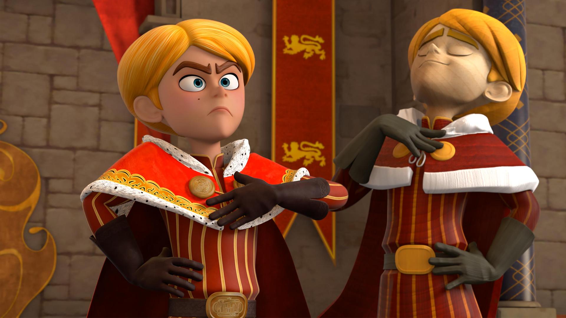 Im Schloss steht Prinz John mit stolz hervorgestreckter Brust und gerader Haltung vor seinem Thron. Er nimmt eine hoheitsvolle Geste an. Neben ihm steht eine lebensechte Statue von ihm.