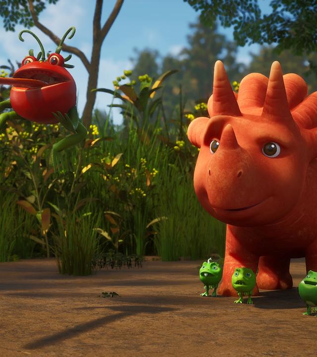 Im Bild sehen wir ein Tomatodon, das rückwärts durch die Luft fliegt. Das rote Wesen, das aussieht wie eine Tomate und ein Frosch, hat seine lange, rote Zunge weit aus dem Mund gestreckt. Etwas dahinter stehen Ginger und die Erbs-Rexe und staunen über das, was sie gerade sehen. (Erbs-Rexe sind Wesen, die aussehen wie Erbsen mit Gesichtern und Ärmchen und Beinchen. Ginger ist ein Trikarottops-Mädchen und sieht aus wie eine Karotte mit Gesicht.)