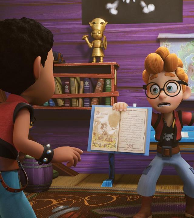 In einem Raum des Schulschiffs Galeone, wo sich Alexander und Finn befinden, hängt ein Bücherregal an der Wand. Alexander hält mit wütendem Gesichtsausdruck ein aufgeschlagenes Heft direkt vor Finns Gesicht. Finn ist nur von hinten zu sehen.