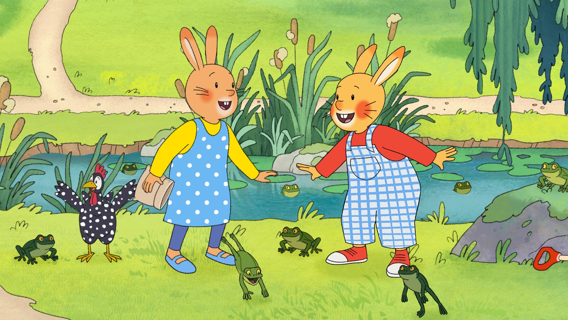 Vor einem Froschteich stehen Monika und Karlchen und lachen sich an. Um sie herum hüpfen viele grüne Frösche. Auch Perlhuhn steht dabei. 