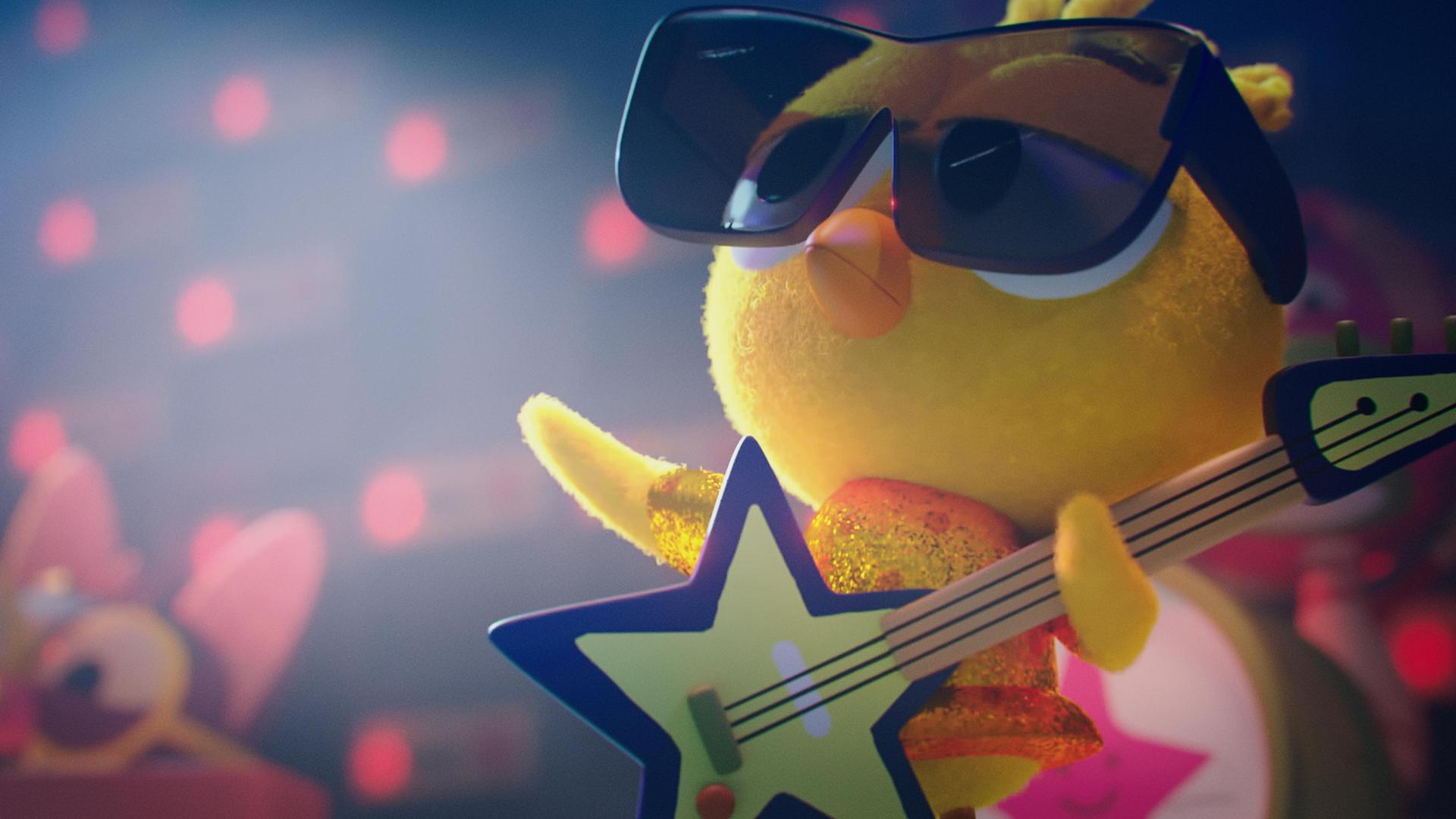 In Karlas Vorstellung: Karla, das Küken, steht in einem glitzernden Outfit auf der Bühne. Auf dem Schnabel trägt sie eine große Sonnenbrille. In den Flügeln hält sie eine sternförmige E-Gitarre. Ihr Blick ist cool.
