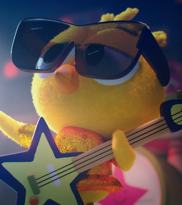 In Karlas Vorstellung: Karla, das Küken, steht in einem glitzernden Outfit auf der Bühne. Auf dem Schnabel trägt sie eine große Sonnenbrille. In den Flügeln hält sie eine sternförmige E-Gitarre. Ihr Blick ist cool.