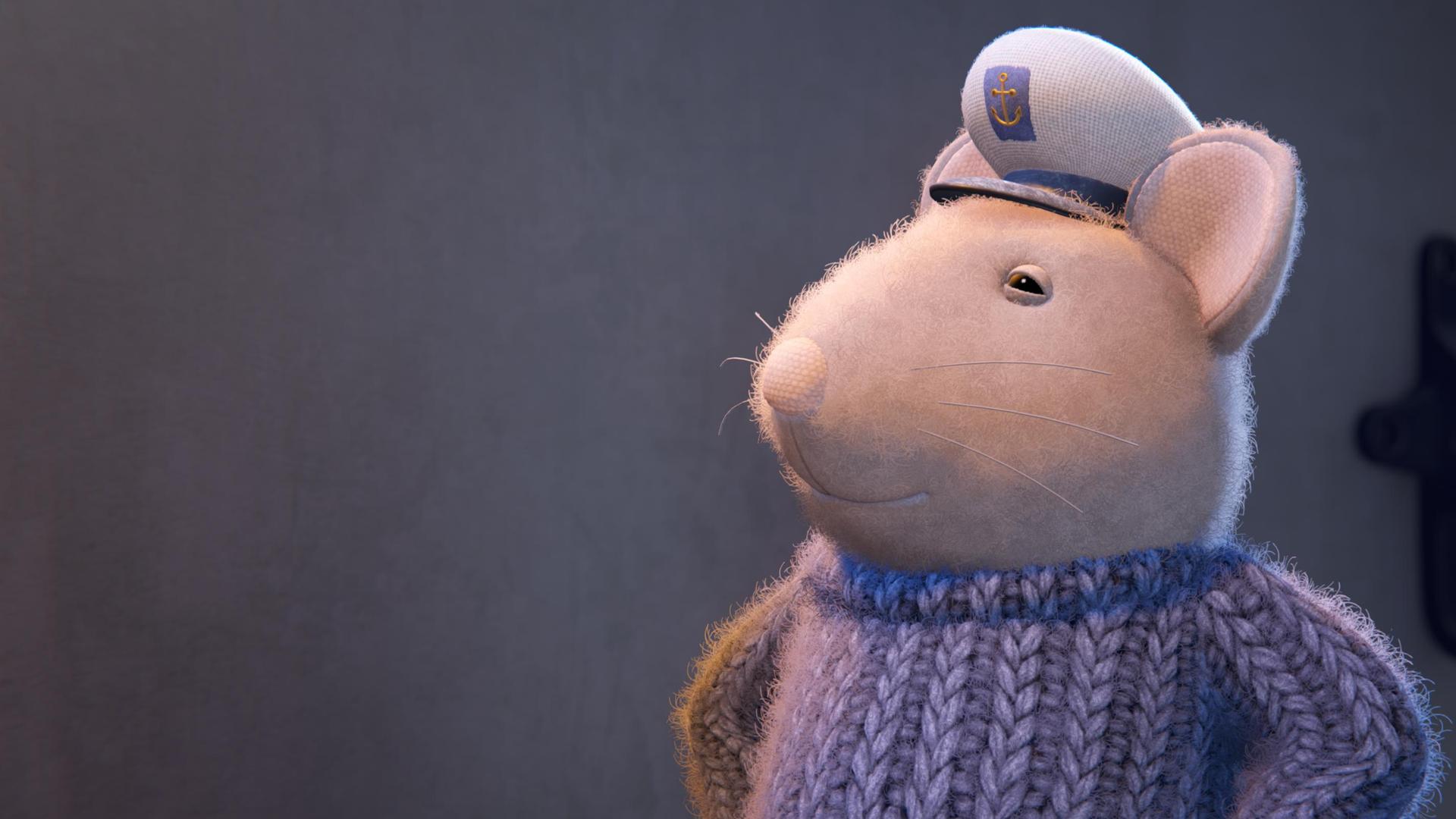 Sam trägt stolz die Seemannsmütze auf dem Kopf und grinst vor sich hin.