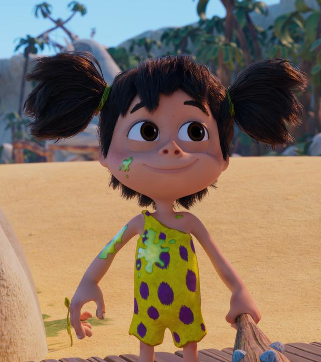 Das Urzeitmädchen Lucy mit den dunklen Zöpfen und den Kulleraugen hat grüne Flecken auf ihrem gelb-lilafarbenen Fellhosenanzug. Trotzdem blickt sie zufrieden drein, ihre Keule in der Hand.