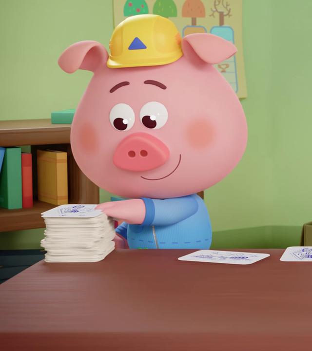 Die Werkel-Ferkel fertigen in ihrer Werkstatt Einladungen an. Charly macht die Karte, Cornelia schnappt sich einen gelben Umschlag und Caesar macht noch den Werkel-Ferkel-Stempel darauf. 