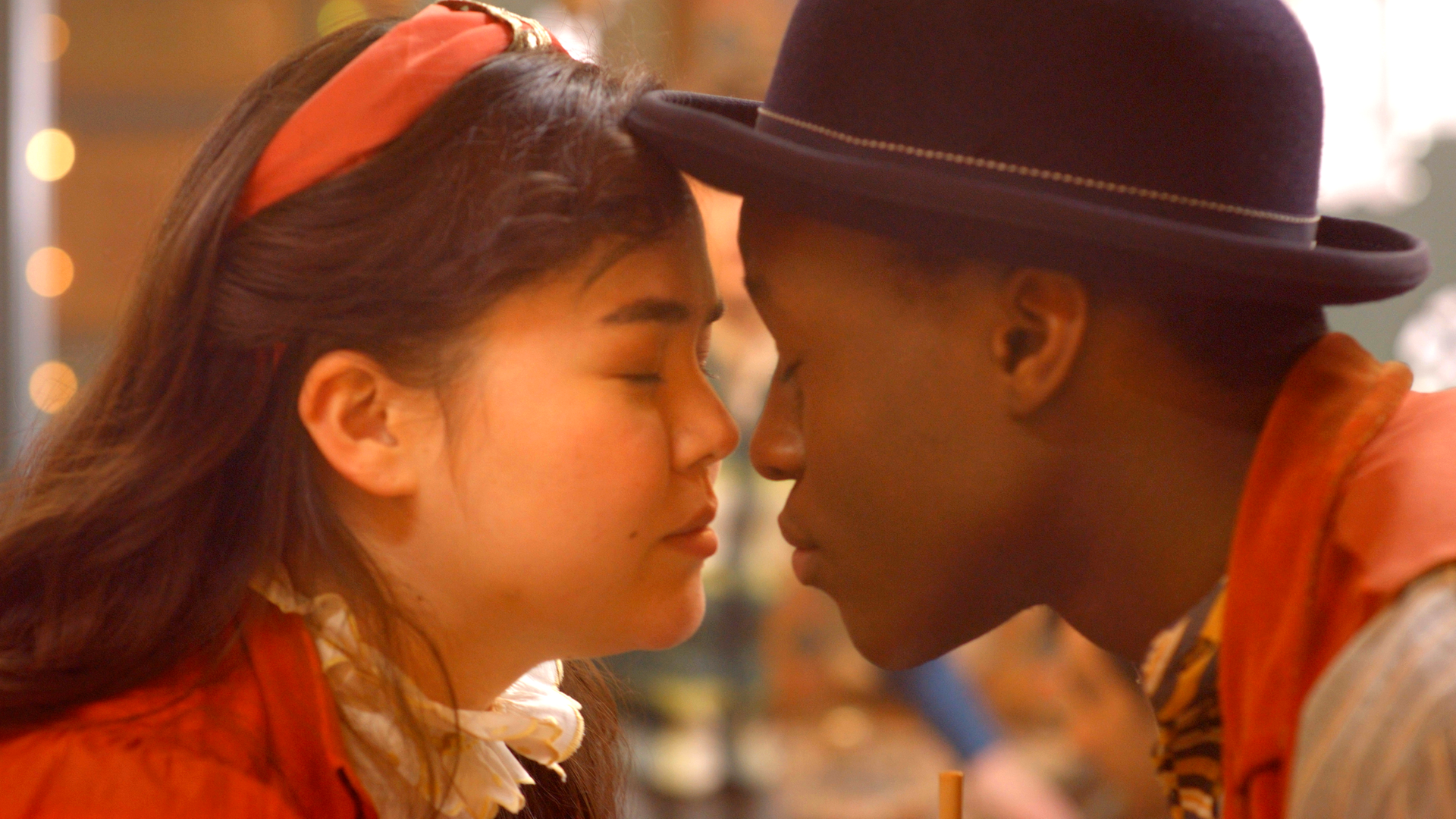 Josie und Will sind mit den Köpfen ganz nah. Ihre Augen sind geschlossen und ihre Nasen berühren sich fast.