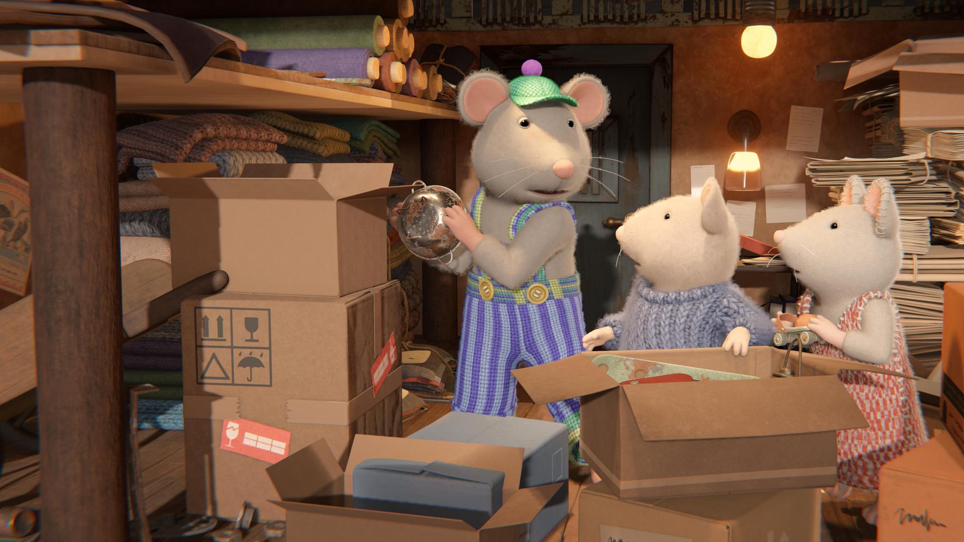 Sam und Julia stehen vor einem großen, aufgeklappten Karton und schauen von der Seite auf Onkel Lumpi, der im Keller ein Sieb in eine Kiste räumt.