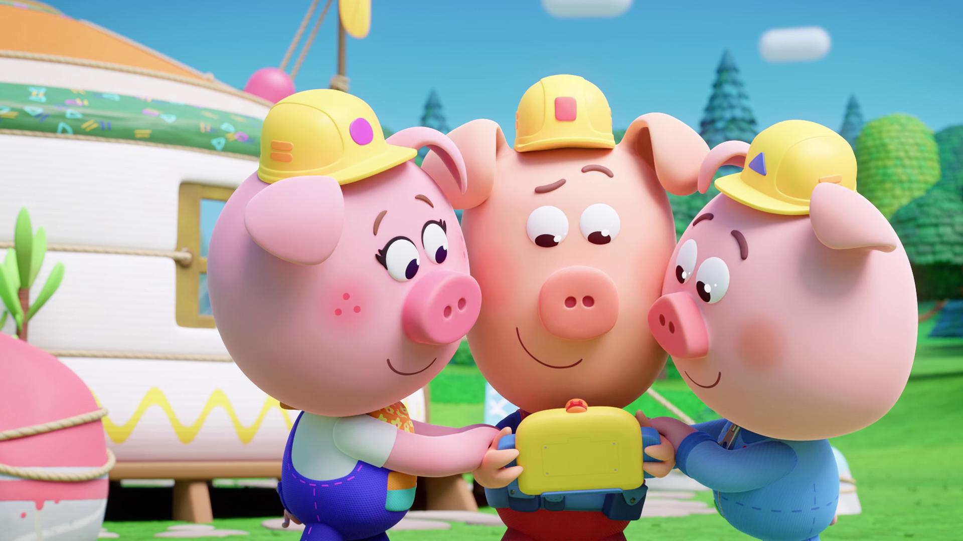 Drei Schweinchen mit Bauarbeiter-Helmen, die Werkel-Ferkel, spielen gemeinsam ein gelbes, kleines Videospiel. 