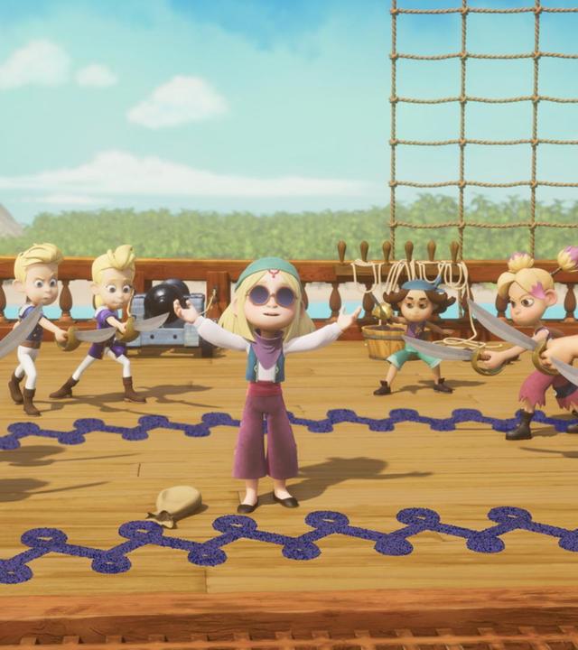 Alle Schüler der Pirate Academy stehen auf Deck. Im Kreis haben sie sich mit ihren Schwertern angriffslustig um Elisa gestellt, die in der Mitte mit ausgestreckten Armen in den Himmel schaut.