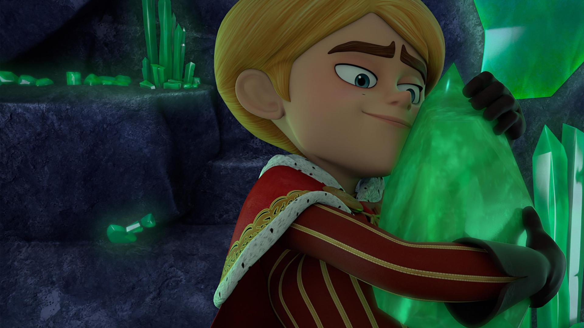 In einer dunklen, felsigen Höhle hält Prinz John fast zärtlich einen großen, grün schimmernden Smaragd in seinen Händen und presst ihn an seinen Oberkörper. Dabei lächelt er glücklich. Um ihn herum sind viele dieser Smaragdkristalle in unterschiedlichen Formen und Größen.