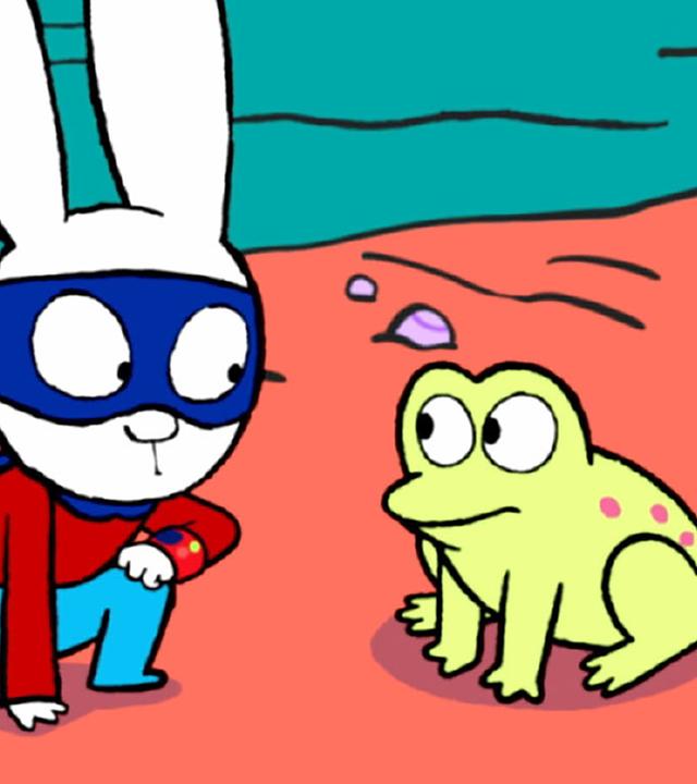 In der Fantasiewelt stehen Captain Hase und Superhase an einem Teich. Superhase kniet fragend vor einem Frosch, der neben ihnen auf dem Boden sitzt. Captain Hase steht hinter Superhase und beobachtet ihn und den Frosch verdutzt.