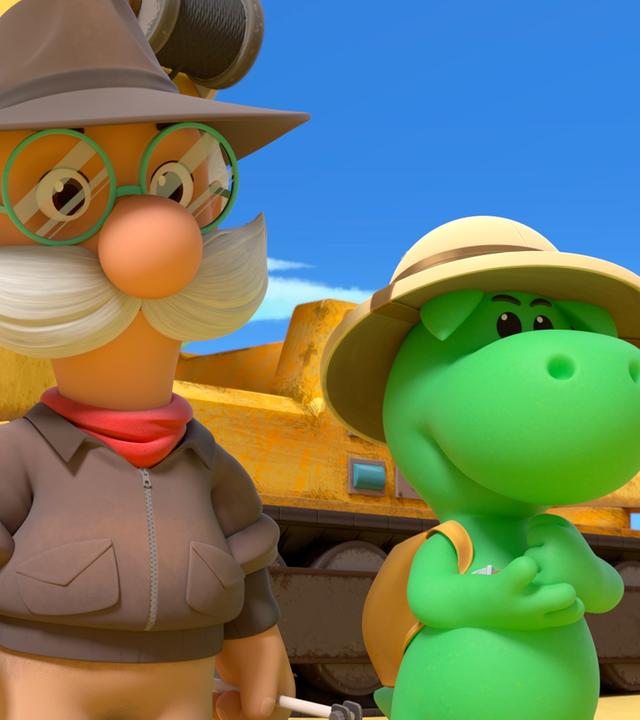 Grisu, der kleine Drache, und sein Freund Professor Smeraldo sind in der Wüste. Im Hintergrund ist ein großer Kranbagger zu sehen.