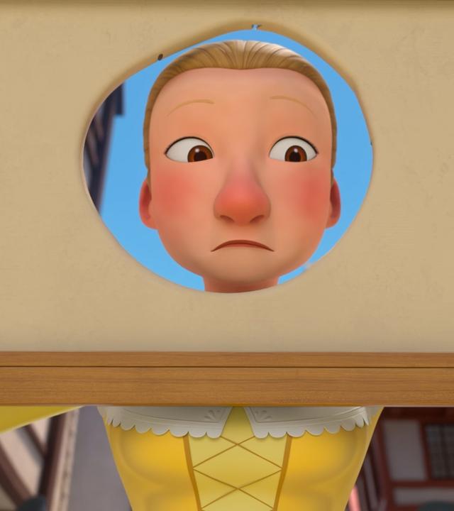 Constance hält mit unglaubwürdigem Blick ein Gemälde in ihren beiden Händen, in dem sich in der Mitte ein großes Loch befindet, durch das sie ihren Kopf steckt.