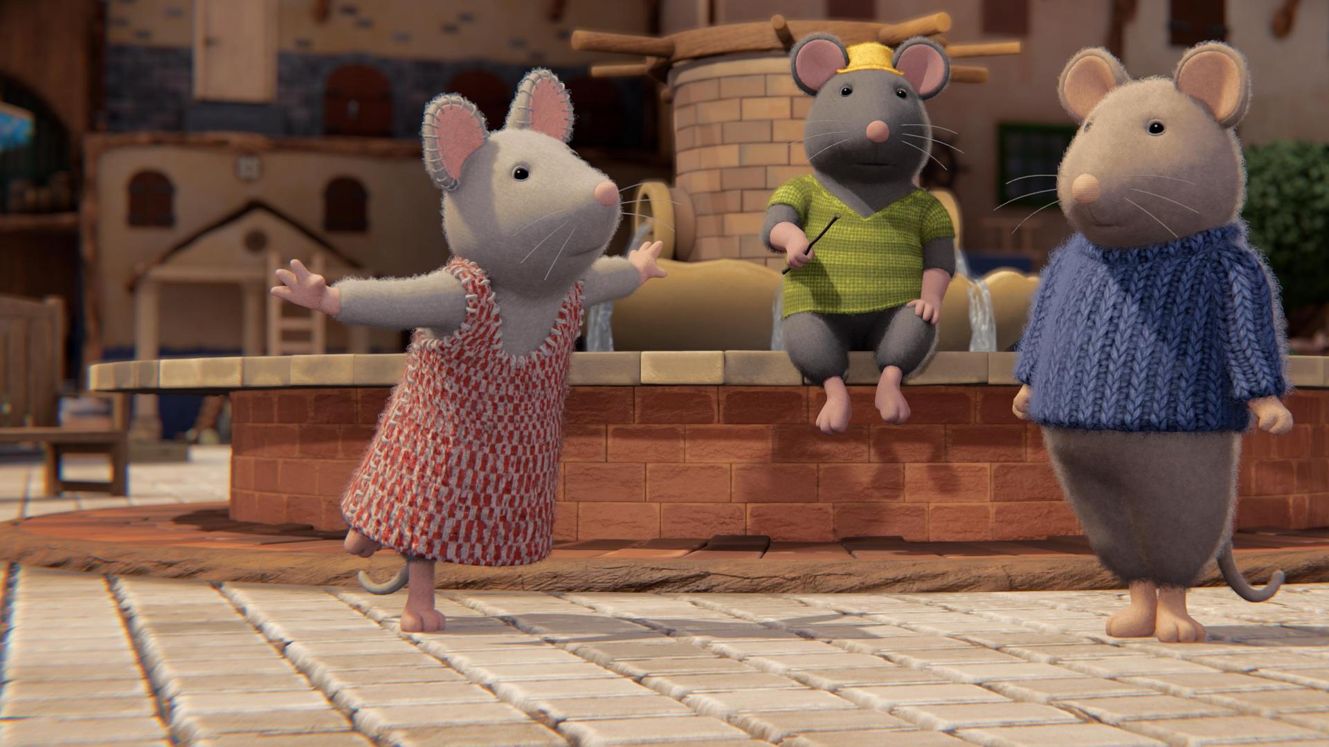 Tonio sitzt regungslos auf dem Brunnenrand im Hof des Mäusehauses. Er hält einen Stab in der rechten Hand. Julia und Sam stehen seitlich vor ihm und schauen erstaunt zu ihm hoch.