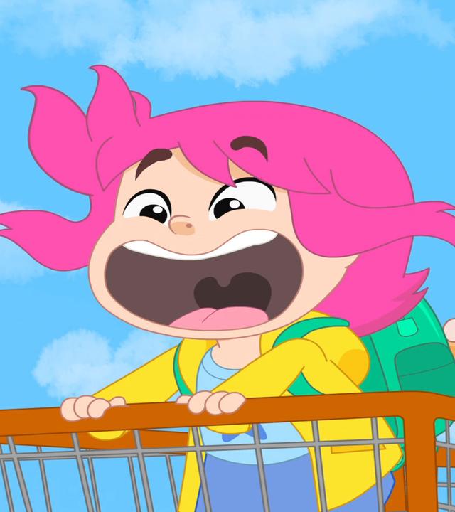 Rebecca steht in einem Einkaufswagen, der von Pierrick geschoben wird. 