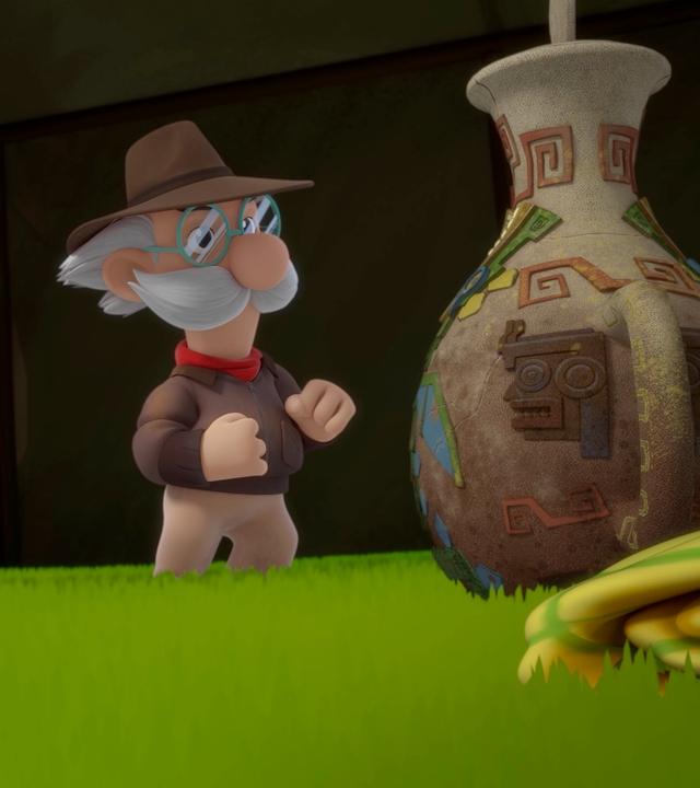 Grisu, der kleine Drache, trägt einen Tropenhelm. Er steht neben Professor Smeraldo und bewundert eine alt aussehende Vase mit Henkel und Deckel.