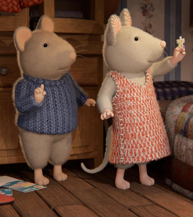 Sam und Julia stehen im Kinderzimmer neben Sams Bett. Julia hält ein Puzzleteil mit der linken Hand in die Höhe. Sie und Sam schauen verwundert darauf.