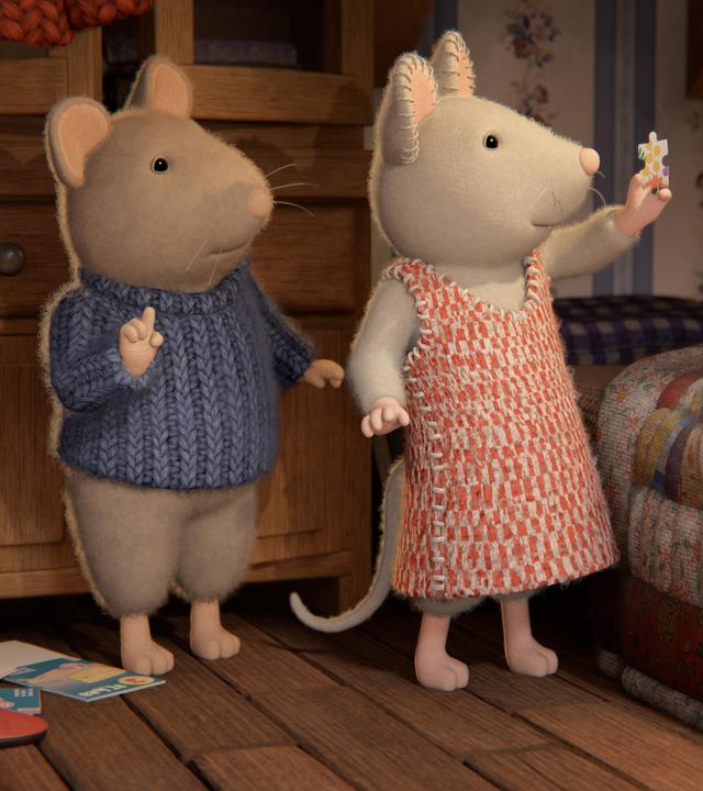 Sam und Julia stehen im Kinderzimmer neben Sams Bett. Julia hält ein Puzzleteil mit der linken Hand in die Höhe. Sie und Sam schauen verwundert darauf.