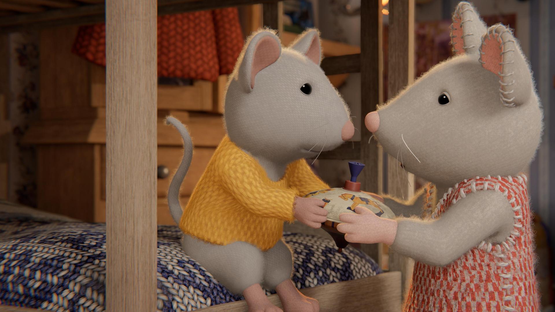 Ben sitzt im Kinderzimmer auf dem unteren Bett eines Stockbettes und überreicht Julia, die vor ihm steht, einen Spielzeugkreisel. Beide schauen einander an.