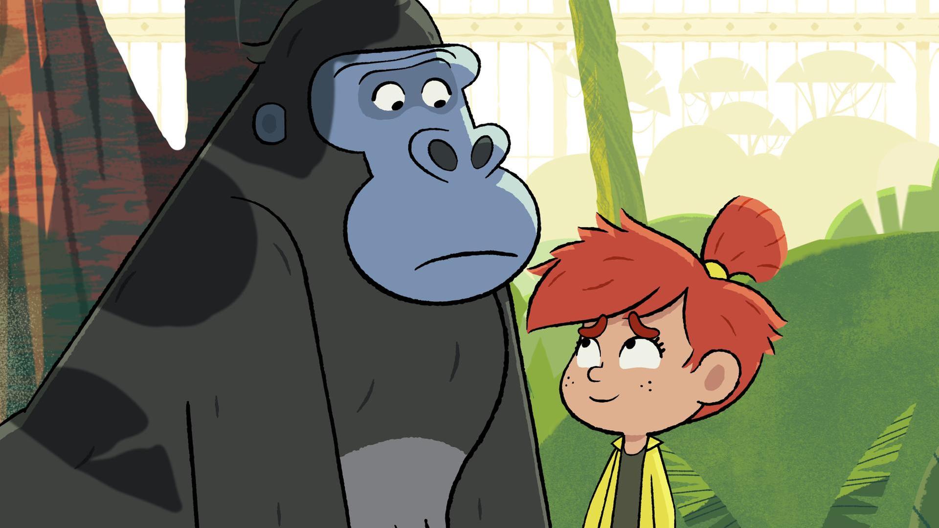 Taylor steht lächelnd vor dem traurig blickenden Gorilla Jack.