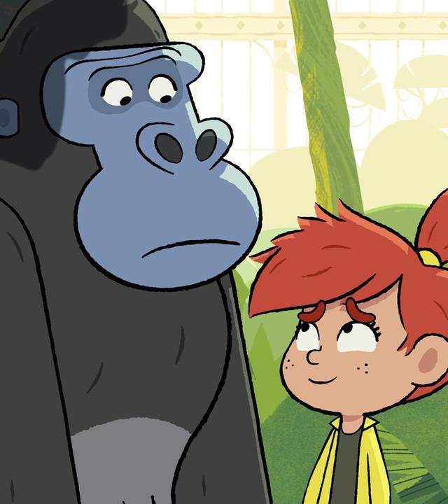 Taylor steht lächelnd vor dem traurig blickenden Gorilla Jack.