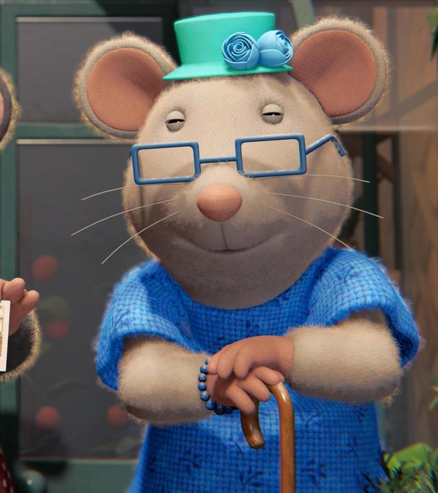 Oma Gouda und ihre alte Freundin stehen nebeneinander vor dem Gewächshaus auf der Terrasse des Mäusehauses. Oma Gouda trägt im rechten Arm einen Korb, ihre Freundin stützt sich auf einen Stock. Beide tragen Brillen und schauen zufrieden nach vorne.